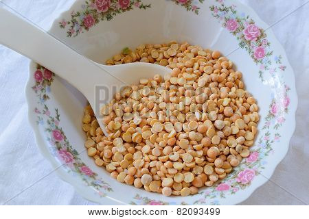 Yellow Peas In A Bowl With White Spoon