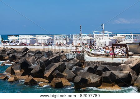 An unidentified locals relaxing on the beach around quay in Beirut
