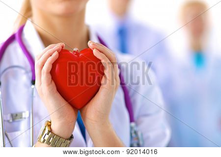 Female doctor with stethoscope holding heart.