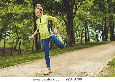 Woman doing stretching exercise before running 