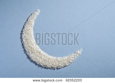 Uncooked rice arranged in moon shape. Ramadan food. A concept.