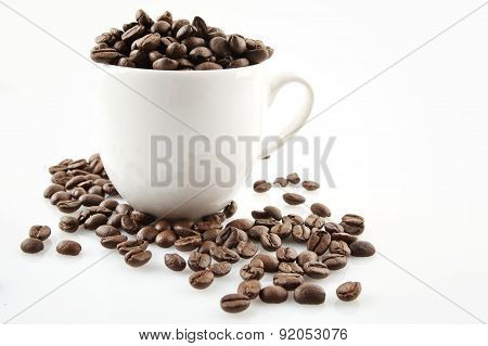 Coffee Cup Full Of Coffee Beans On White