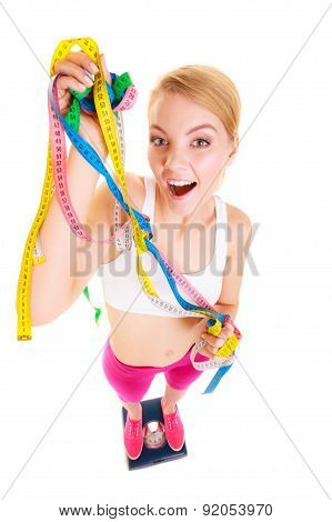 Joyful Woman On Weighing Scale. Slimming Diet.