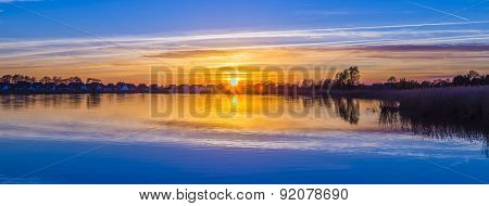 Sunset In Zinnowitz With Reflection On The Water