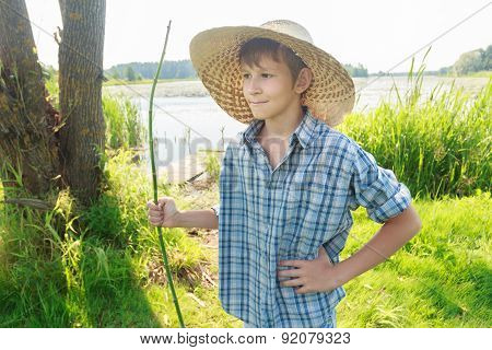 Three-quarter View Portrait Of Standing Angler Teenage Boy Wearing Plaid Shirt And Straw Hat