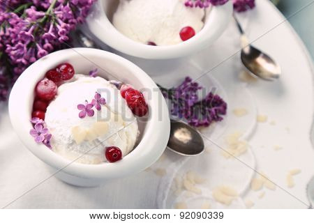 Beautiful composition with tasty ice cream and lilac flowers