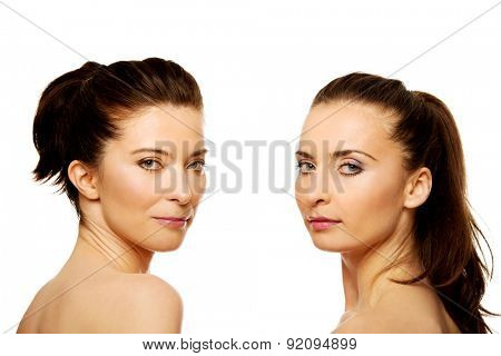 Two attractive topless sisters with make up.