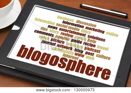blogosphere word cloud on a digital tablet with a cup of tea - blogging concept