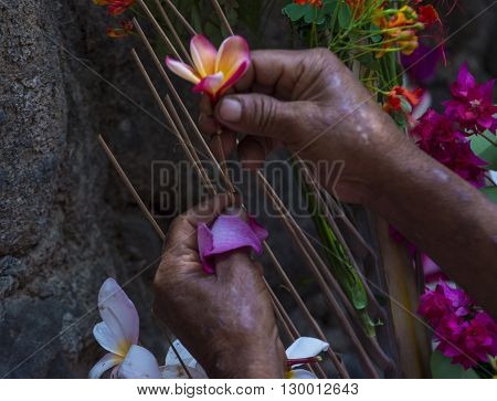 PANCHIMALCO EL SALVADOR - MAY 08 : A Salvadoran woman decorates palm fronds with flowers during the Flower & Palm Festival in Panchimalco El Salvador on May 08 2016