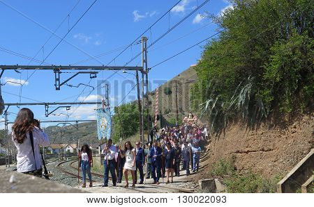 Alora Spain 24 April 2016: Religious procession crossing railway line near Alora Andalucia. Alora Spain 24 April 2016