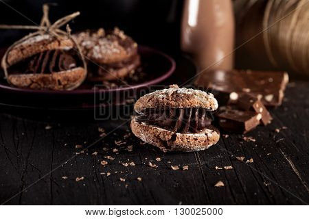 Italian maroni cookies with pieces of chocolate on old wooden background