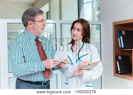 The patient and his doctor in medical office. Healthcare concept