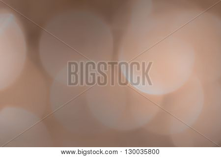 Abstract defocused chrystals, large bright circles in apricot and gray.