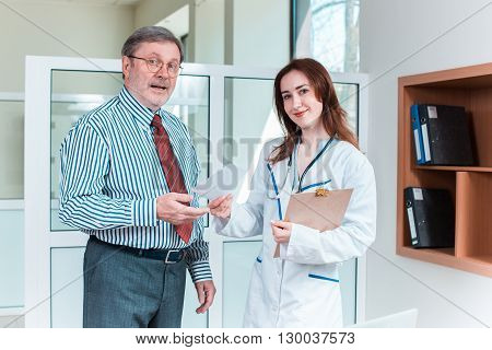 The patient and his doctor in medical office. Healthcare concept