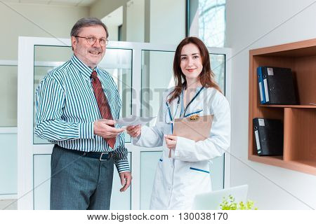The patient and his doctor in medical office. Healthcare concept