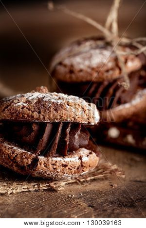 Italian maroni cookies with pieces of chocolate on old wooden background