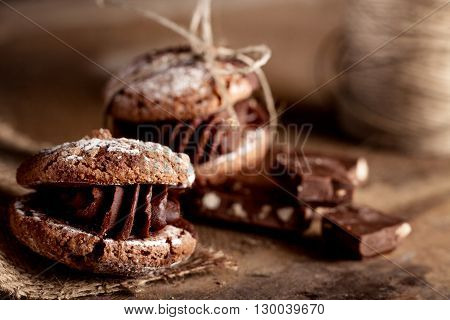 Italian maroni cookies with pieces of chocolate on old wooden background