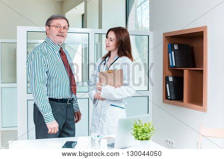 The patient and his doctor in medical office. Healthcare concept