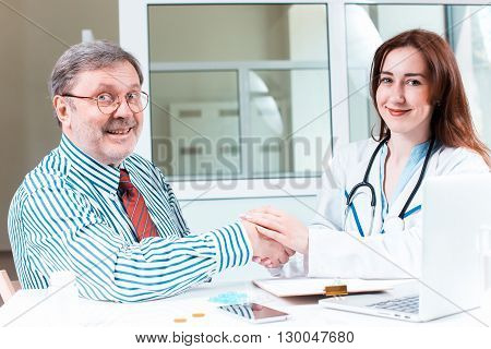 The patient and his doctor in medical office. Healthcare concept