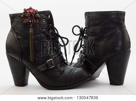 Pair of female black lace boots isolated on white background