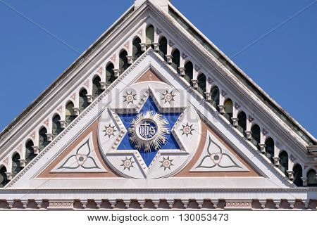 FLORENCE, ITALY - JUNE 05: IHS sign, Basilica di Santa Croce (Basilica of the Holy Cross) - famous Franciscan church in Florence, Italy, on June 05, 2015