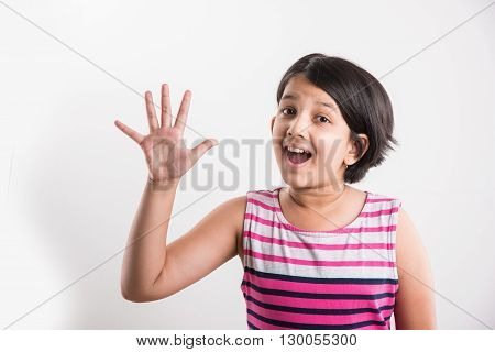 indian small girl counting five, asian small girl showing 5 fingers or five numbers with fingers