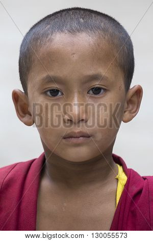 DHARAMSALA INDIA - SEPTEMBER 24 2014: An unidentified young Tibetan Buddhist monk in the Dharamsala near Dalai Lama's residence.