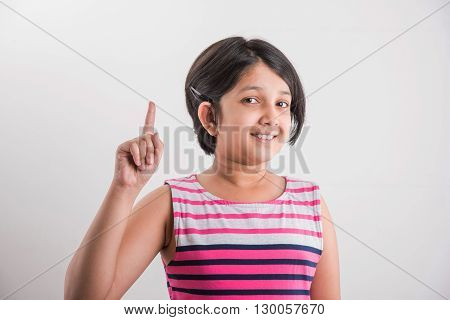 indian small girl counting one, asian small girl showing 1 finger or one number with index finger