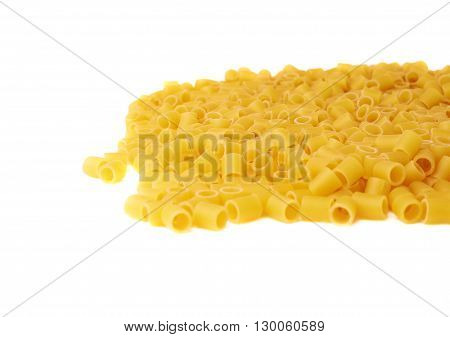 Pile of dry ditalini yellow pasta over isolated white background