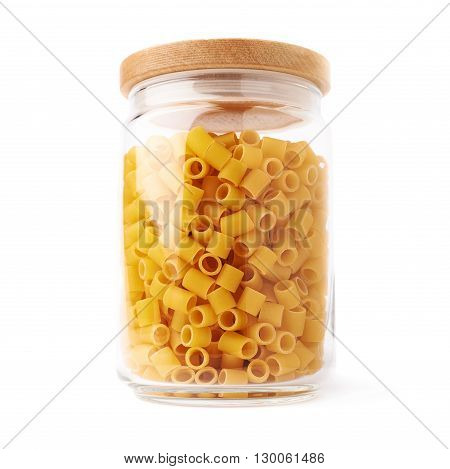 Glass jar filled with dry ditalini yellow pasta over isolated white background