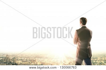 Business man looks sunrise in city, concept for business