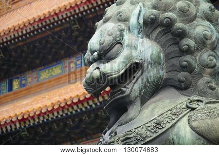 A metal chinese lion statue within the forbidden city in front of the Gate of Supreme harmony (tianhe men) in Beijing China.