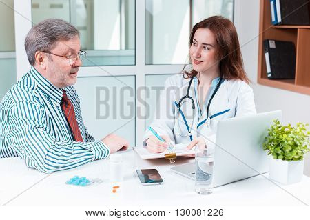 The patient and his doctor in medical office. Healthcare concept