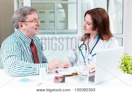 The patient and his doctor in medical office. Healthcare concept