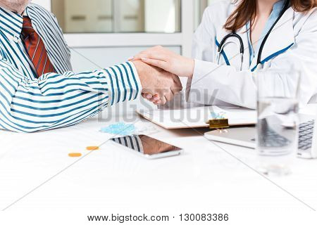 The patient and his doctor in medical office. Healthcare concept