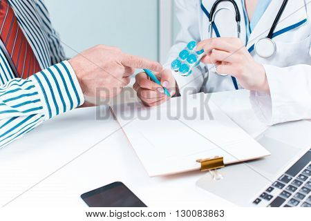 The patient and his doctor in medical office. Healthcare concept