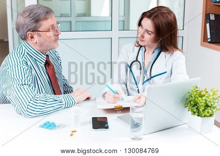 The patient and his doctor in medical office. Healthcare concept