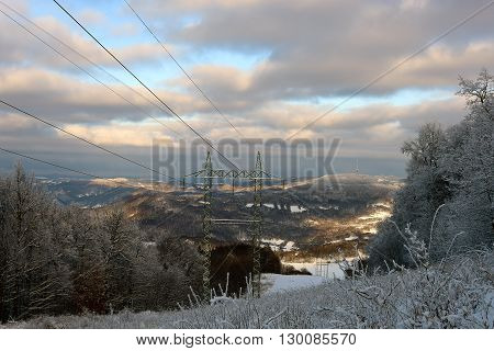 Electric posts in snow mountains in north Bohemia