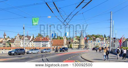 Lucerne, Switzerland - 7 May 2016: pedestrians and traffic on the Seebruecke bridge. The Seebruecke bridge connects the historical and contemporary parts of the city of Lucerne. Lucerne is a city in central Switzerland.