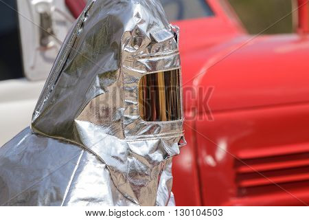 Fireman in special heat resistant suit on a background of fire engine