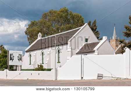 UNIONDALE SOUTH AFRICA - MARCH 5 2016: The Pinkster Protestant Church in Uniondale originally built by the London Missionary Society circa 1843. The Little Theatre Cafe is behind the church