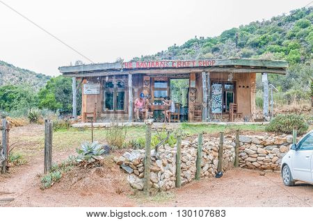 BAVIAANSKLOOF SOUTH AFRICA - MARCH 5 2016: Unidentified tourists at a coffee shop and craft centre in the Baviaanskloof (baboon valley). Falling rain is visible