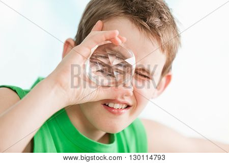 Boy Holding A Multi Faceted Crystal Against Eye