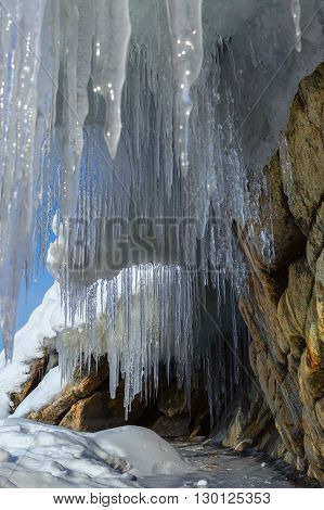 Huge icicles on a cliff. Beautiful winter landscape in the Lake Baikal.