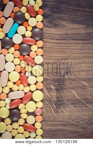 Vintage photo Heap of medical pills capsules or supplements for therapy concept of treatment and health care copy space for text or inscription