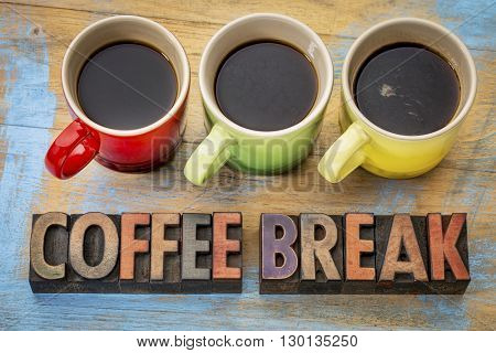 coffee break banner  in vintage letterpress wood type with three cups of espresso coffee
