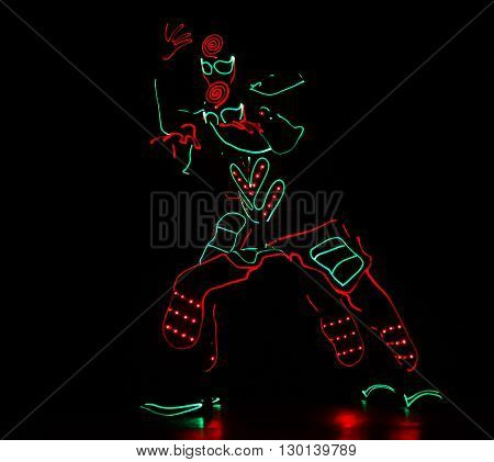 Dancers Crew In Led Suits On Dark Background, Colored Show
