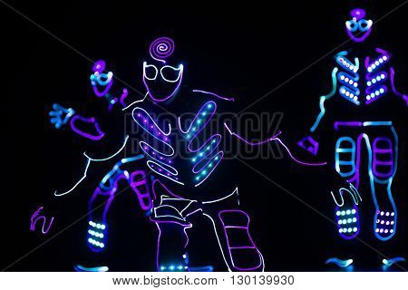Dancers Crew In Led Suits On Dark Background, Colored Show