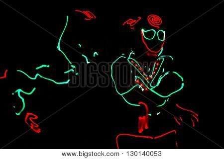 Dancers Crew In Led Suits On Dark Background, Colored Show
