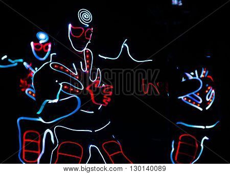 Dancers Crew In Led Suits On Dark Background, Colored Show
